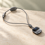 Easewell Graphite LCD neck massager on warm ivory stone — styled product image